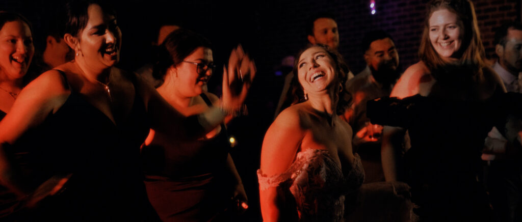 Dallas Wedding Videographer | Adrienne and John | Bethel Rock in Leonard, TX - bride laughing while on dance floor