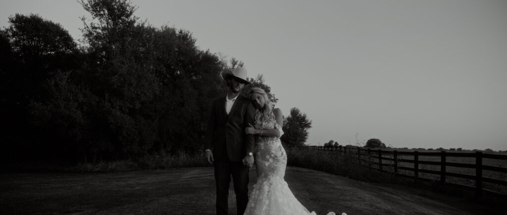 Dallas Wedding Videographer | Brianna and Carter | The Springs Event Venue in Alvarado, TX - couple standing in the field in black and white