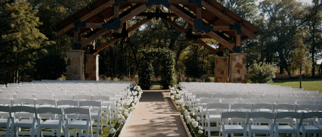 Dallas Wedding Videographer | Brianna and Carter | The Springs Event Venue in Alvarado, TX - ceremony site with beautiful floral arch
