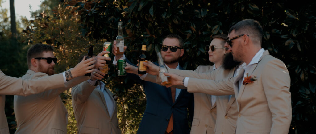Videography for Wedding Dallas | Houston Wedding Videography | Amanda and Jacob | - Jacob and his groomsmen giving a cheers outside