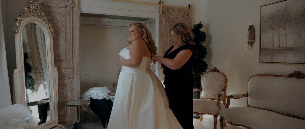 Videography for Wedding Dallas | Houston Wedding Videography | Amanda and Jacob | - Mom helping Amanda getting into her dress