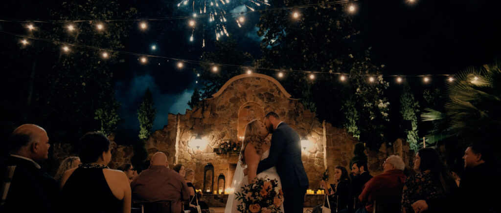 Videography for Wedding Dallas | Houston Wedding Videography | Amanda and Jacob | - kissing in the middle of the aisle as fireworks go off