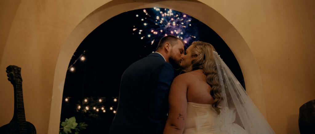 Videography for Wedding Dallas | Houston Wedding Videography | Amanda and Jacob | - bride and groom kissing with fireworks in background