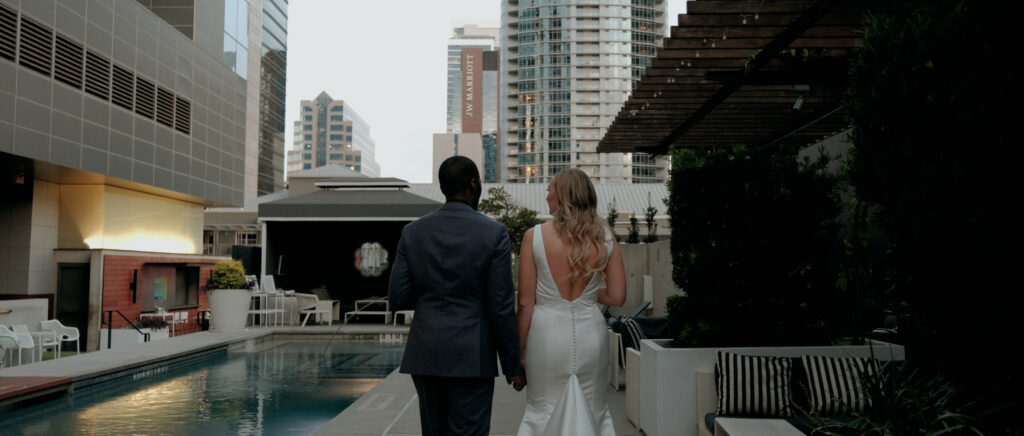 Videography for Wedding Dallas | Austin Wedding Videography | Molly and Oliver | - Couple walking past rooftop pool of W Hotel