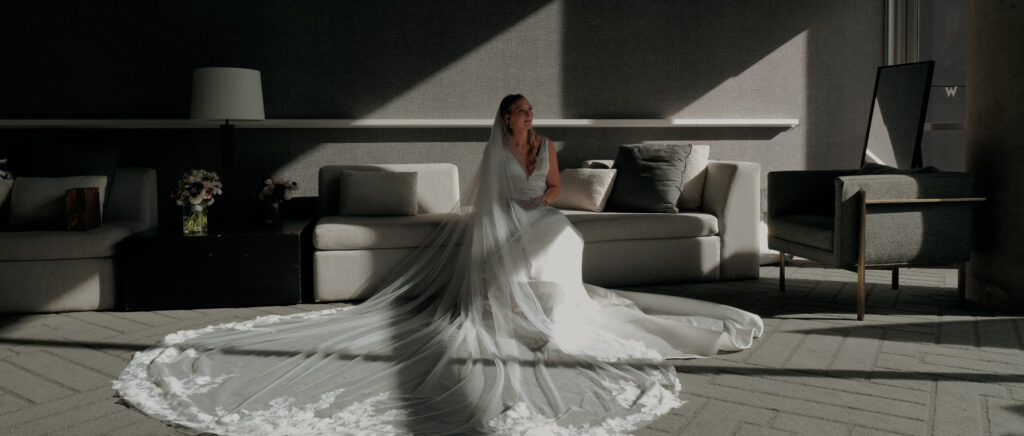 Videography for Wedding Dallas | Austin Wedding Videography | Molly and Oliver | - Molly with her dress sitting on the couch
