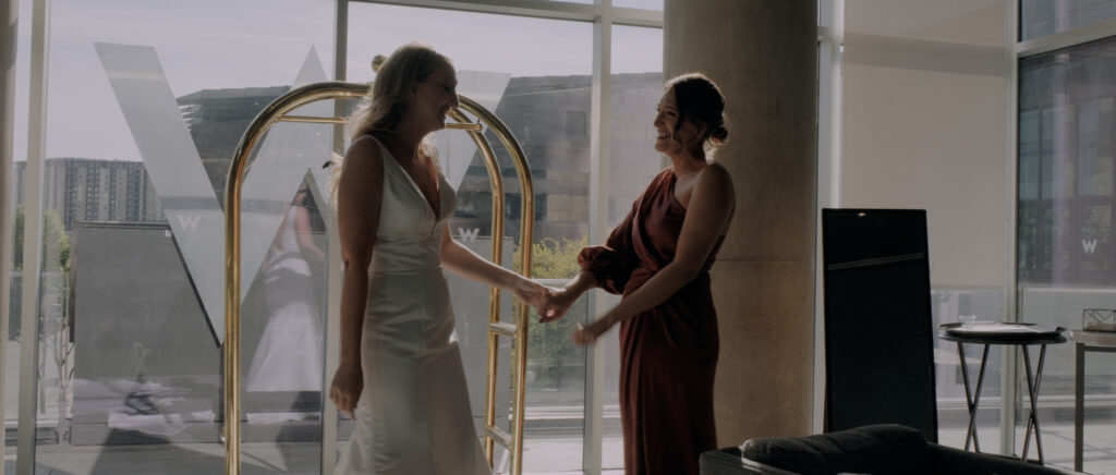 Videography for Wedding Dallas | Austin Wedding Videography | Molly and Oliver | - Molly and her sister laughing as she gets in her dress