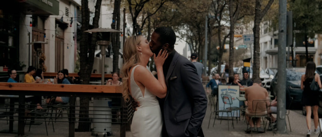 Videography for Wedding Dallas | Austin Wedding Videography | Molly and Oliver | - Molly and Oliver kissing outside in downtown Austin
