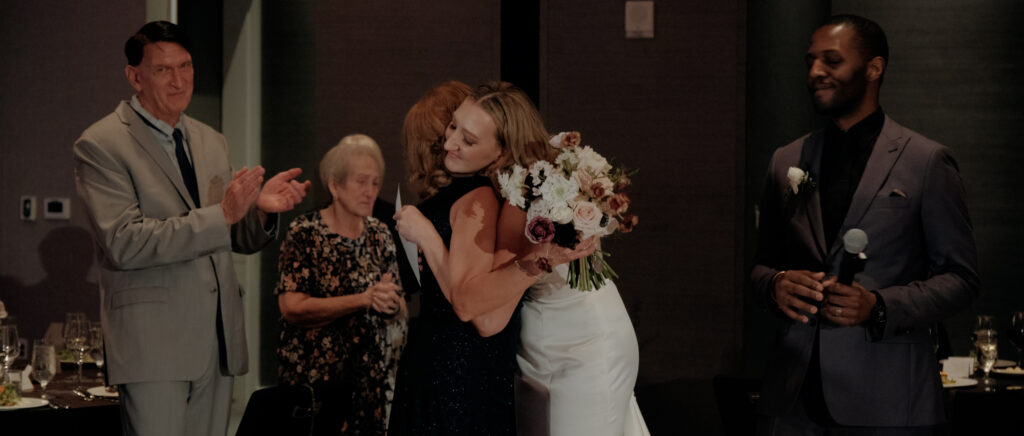 Videography for Wedding Dallas | Austin Wedding Videography | Molly and Oliver | - Molly hugging her mom after dedicating her bouquet to her.