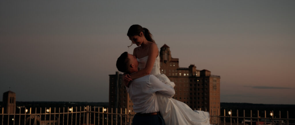 Videography for Wedding Dallas | Tegan and Dayd | - Crazy Water Hotel Wedding Video - bride and groom portraits with groom lifting the bride on rootop